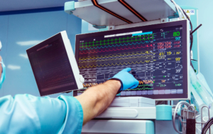 View of a doctor pointing at cardiovascular machine