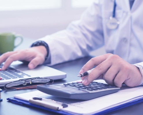 healthcare professional wearing a white coat with stethoscope in hospital