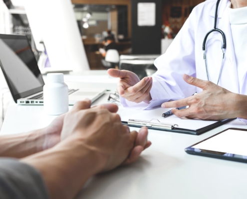 Image of a patient discussing medical bills with their doctor.