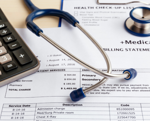 Medical cost concept with calculator and stethoscope